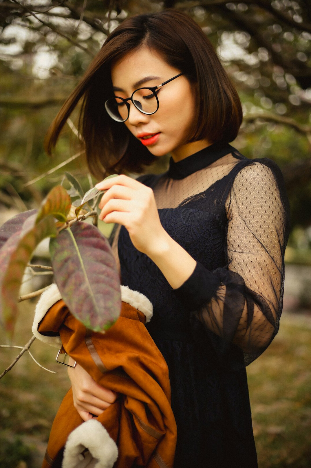 Studio portrait of an East Asian-Canadian woman writer and editor with glasses
