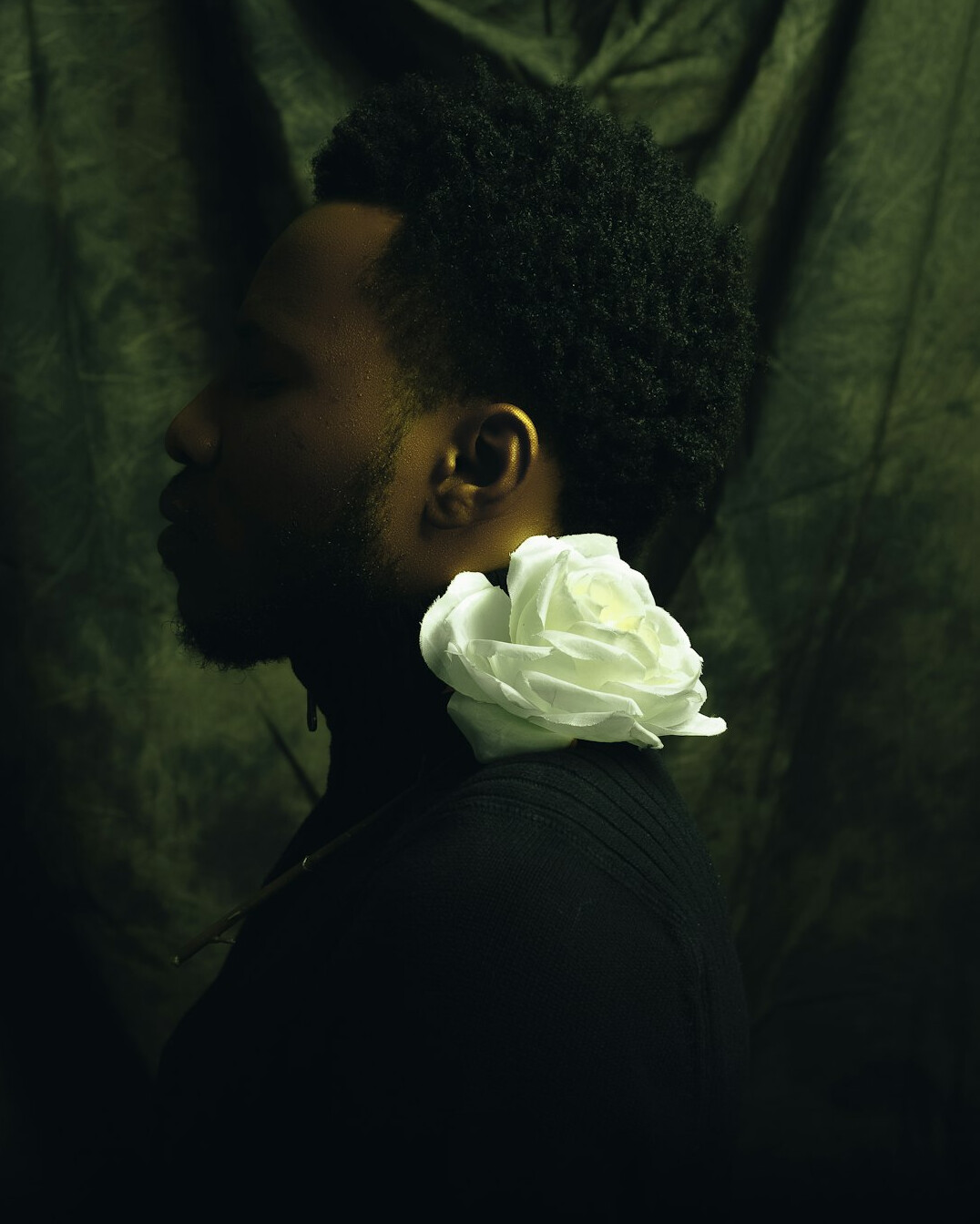Studio portrait of a Black Canadian male documentary photographer with a beard